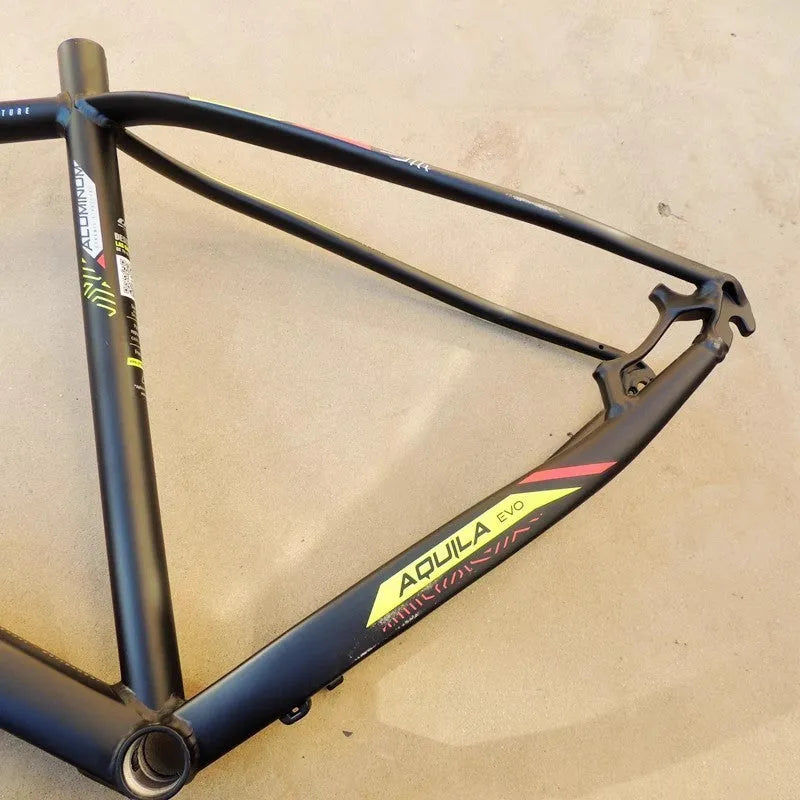 Black green aluminium mountain bike frame showing disc brake mount and internal cable routing ports