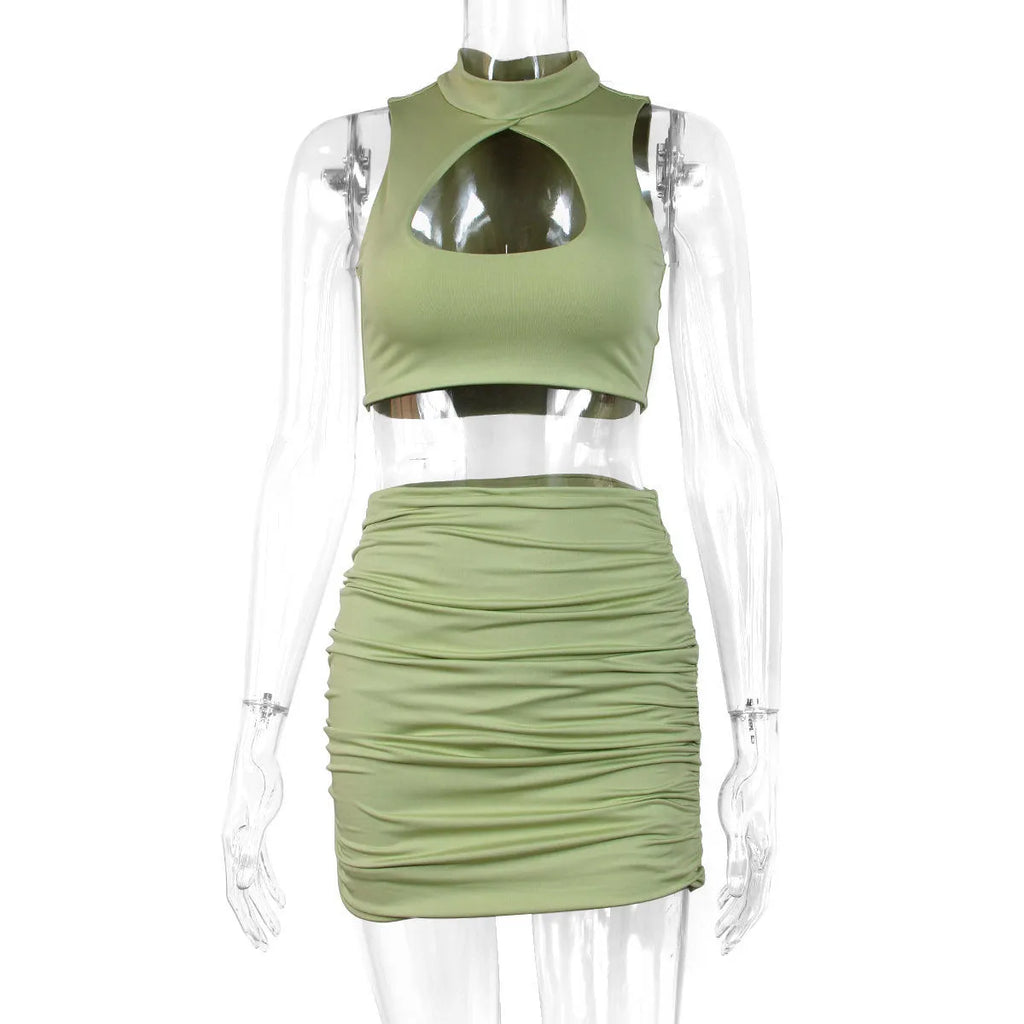 Women's light purple two-piece set with hollow vest top and split skirt on a model.
