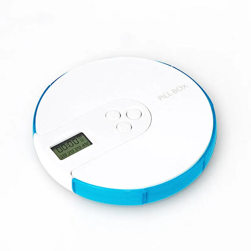Blue 7-compartment alarm clock pill dispenser showing timer display and weekly medicine slots