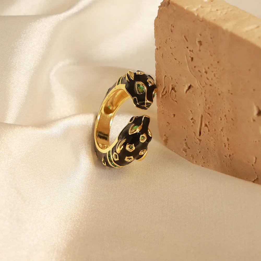 Black cheetah print geometric open ring on finger showing electroplated copper construction