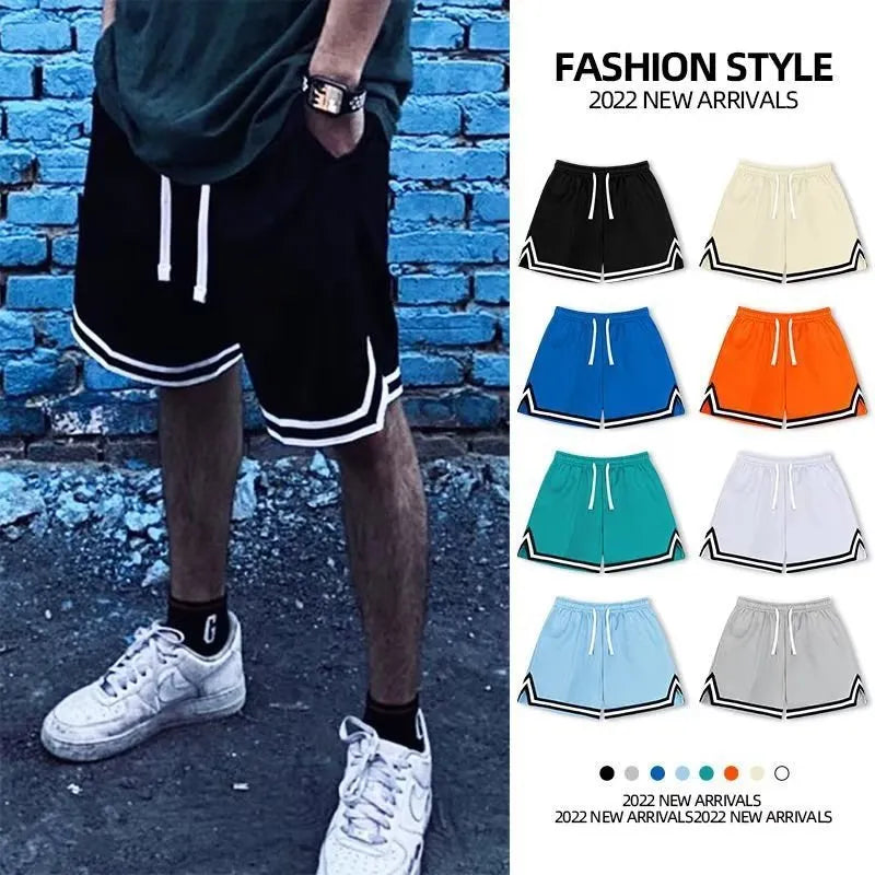 Man wearing loose-fit grey polyester sports shorts with an elasticated waistband.