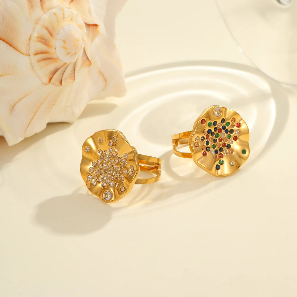 Pleated geometry open mouth ring with inlaid colourful crystals on electroplated stainless steel band.