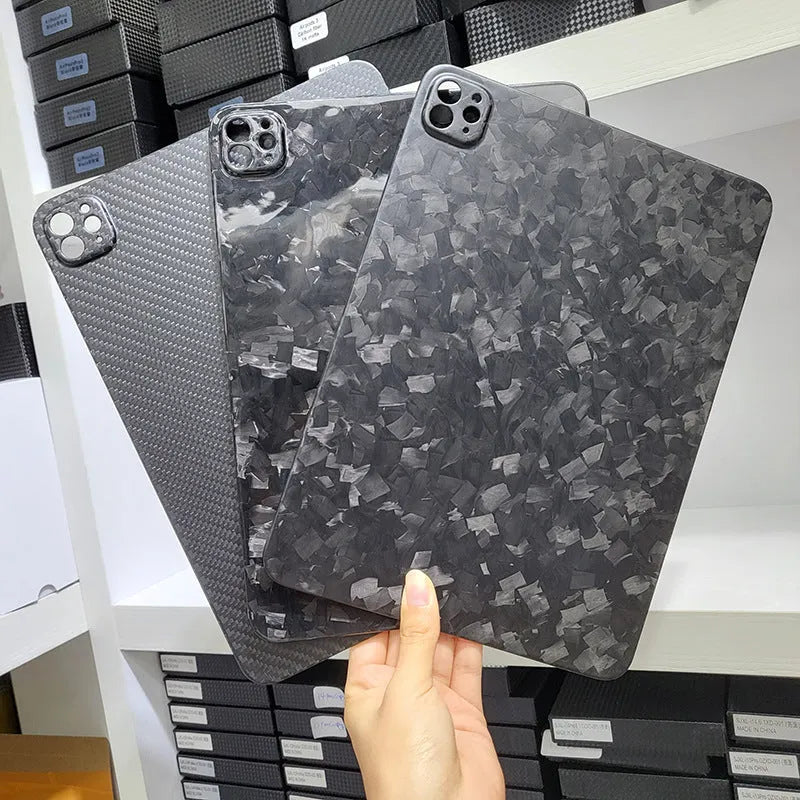 Carbon fibre hard case for Apple iPad Pro 11 showing embossed plaid pattern and matte finish.