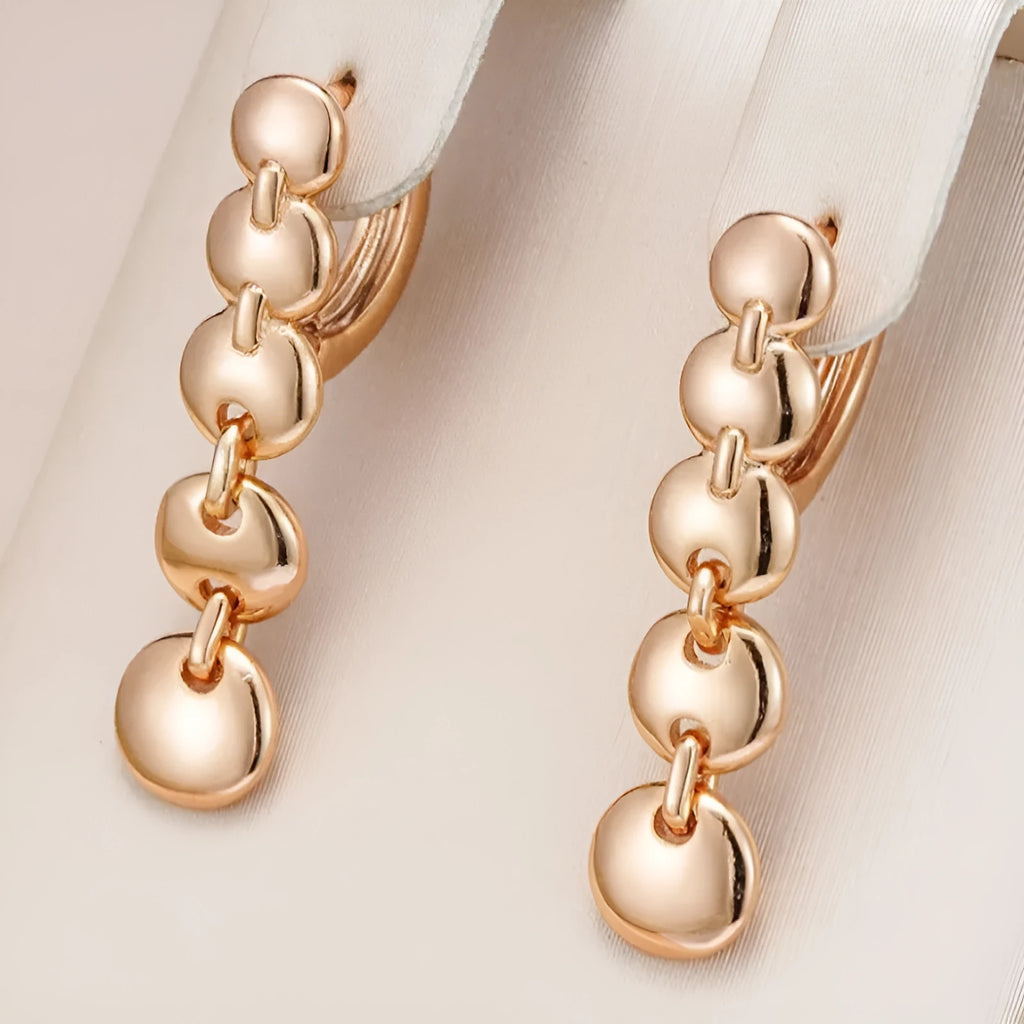 Long gold retro circle earrings with woven chain design, shown from the side.