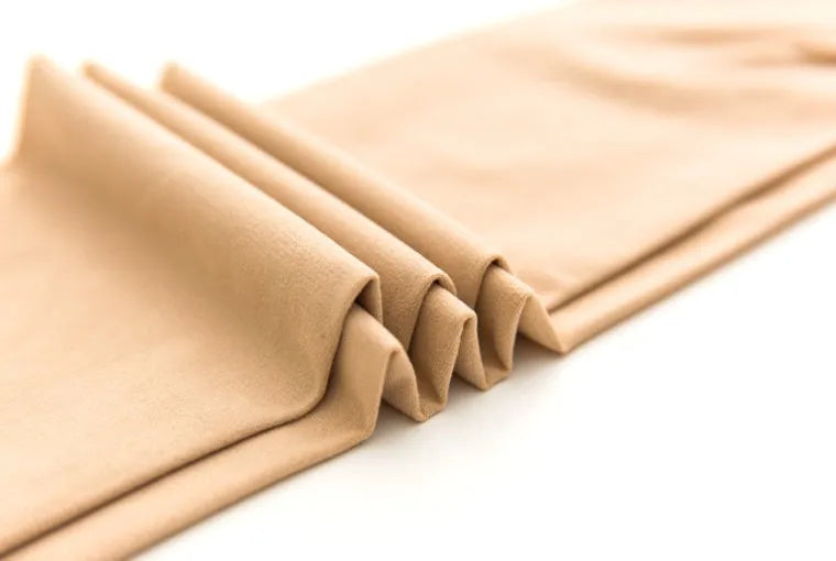 Beige and black stovepipe socks for lifting hips and abdomen, made from polyester fibre.