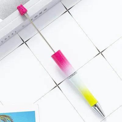 Ballpoint pen with colourful spinning plastic beads on barrel, shown in a gradient purple finish.