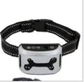 Black digital dog bark training collar with adjustable reflective strap on a table