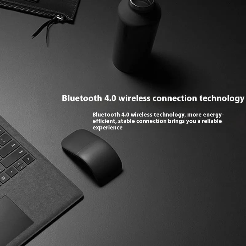 Black foldable Bluetooth touch wireless mouse shown open and closed next to a laptop