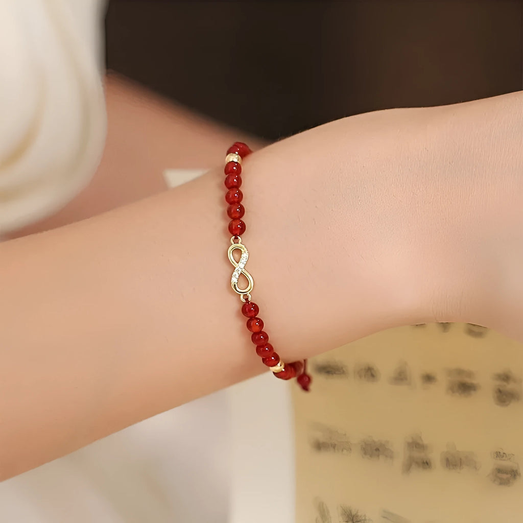 Hand-woven ethnic bracelet with natural red agate beads in diamond shapes showing woven pattern detail