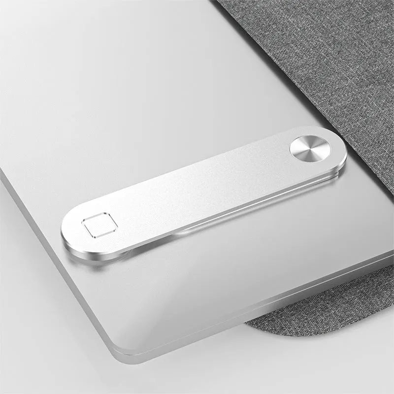 Black aluminium magnetic phone holder clipped to the side of a silver laptop.