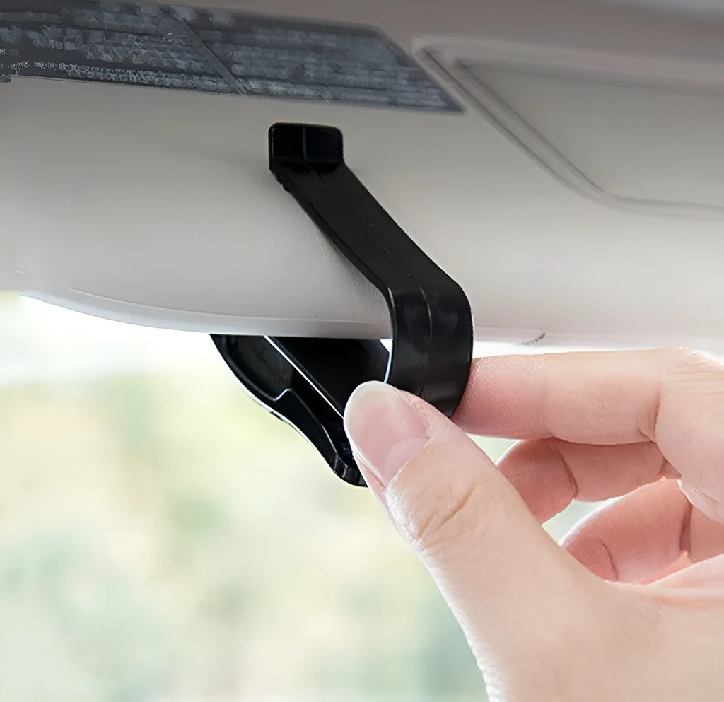 Black plastic multifunctional clip for car sunshade holding sunglasses and cards.