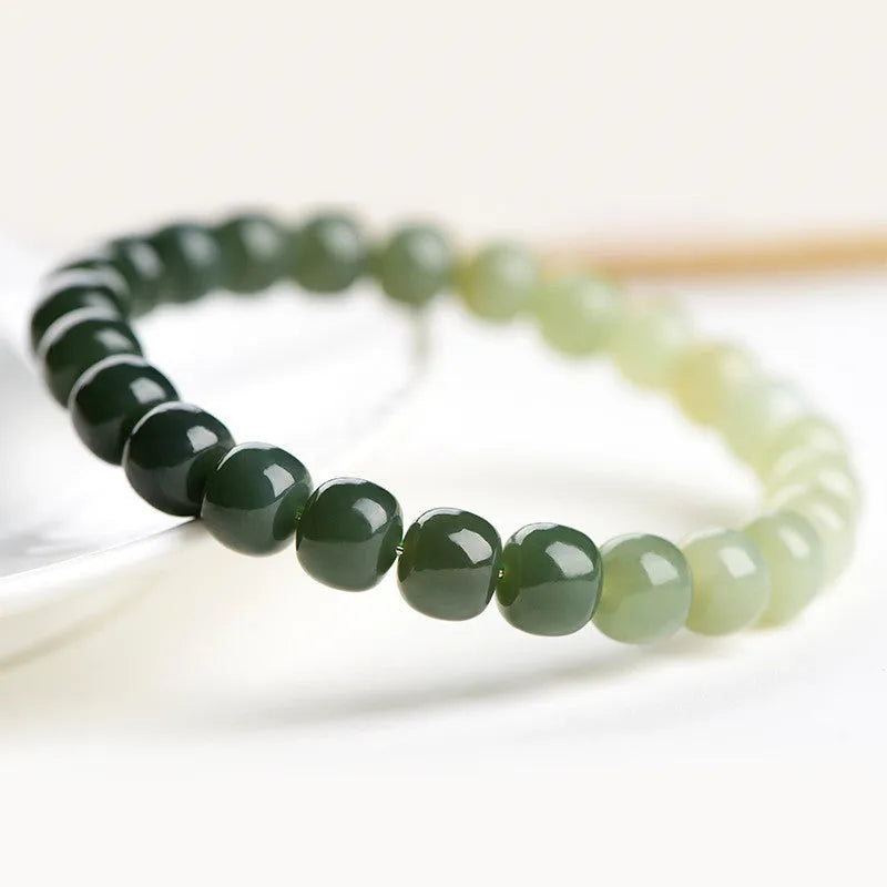 Natural Hetian jade water gradient bracelet with polished beads on an adjustable cord.