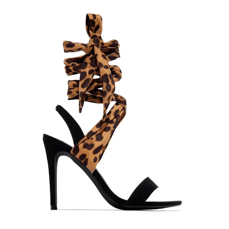 Light brown leopard print women's high heels with cross straps and a fine high heel.