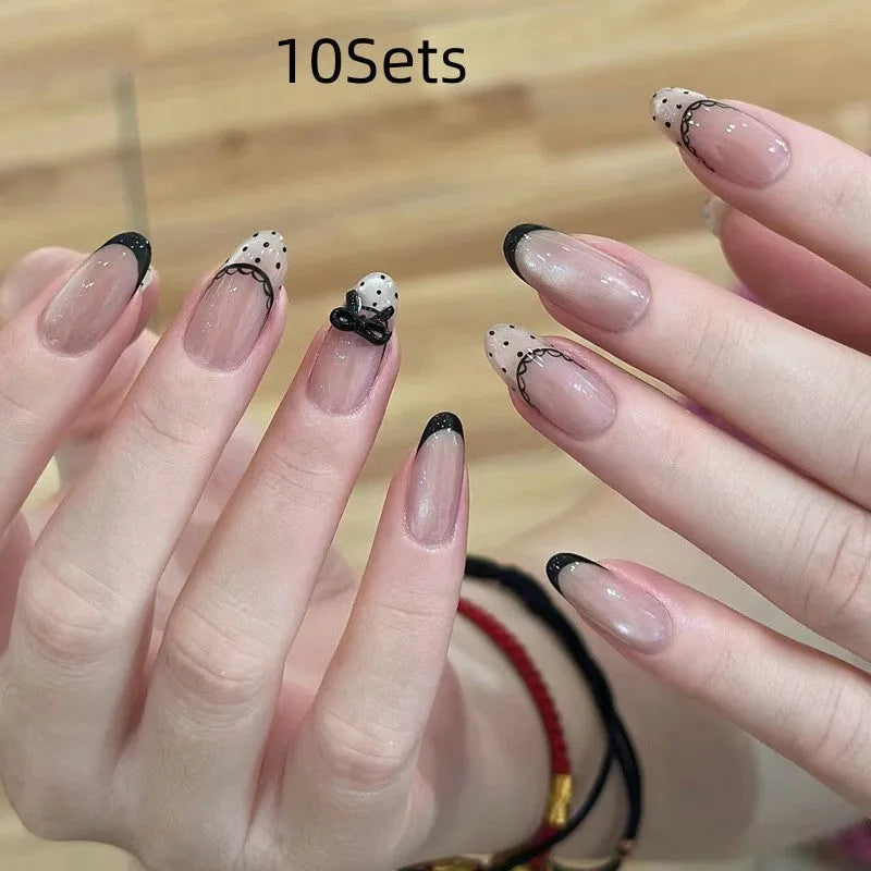 Five sets of short square shaped press-on fake nails with a peel-and-stick backing, shown in assorted colours.