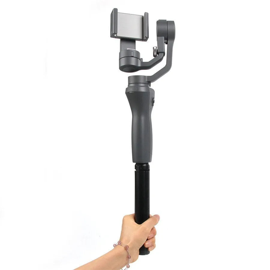 Black aluminium mobile phone tripod stabilizer with PTZ functionality on a table