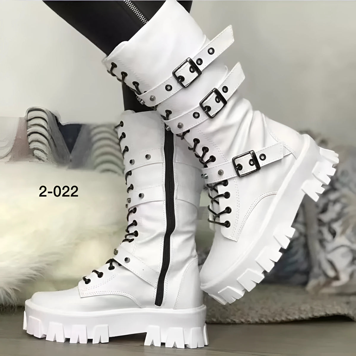 Women's black mid-calf knight boots with a metal buckle strap and side zipper on a round toe.