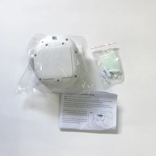 White Atomic Angel induction LED night light with touch sensor on front.