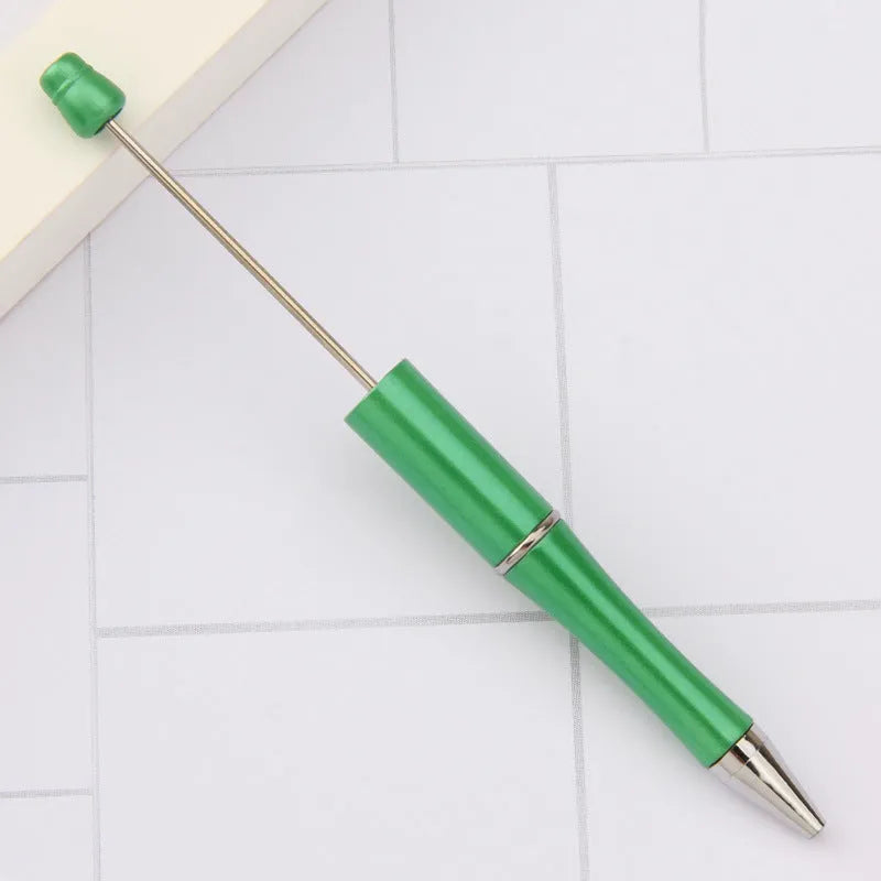 Ballpoint pen with colourful spinning plastic beads on barrel, shown in a gradient purple finish.