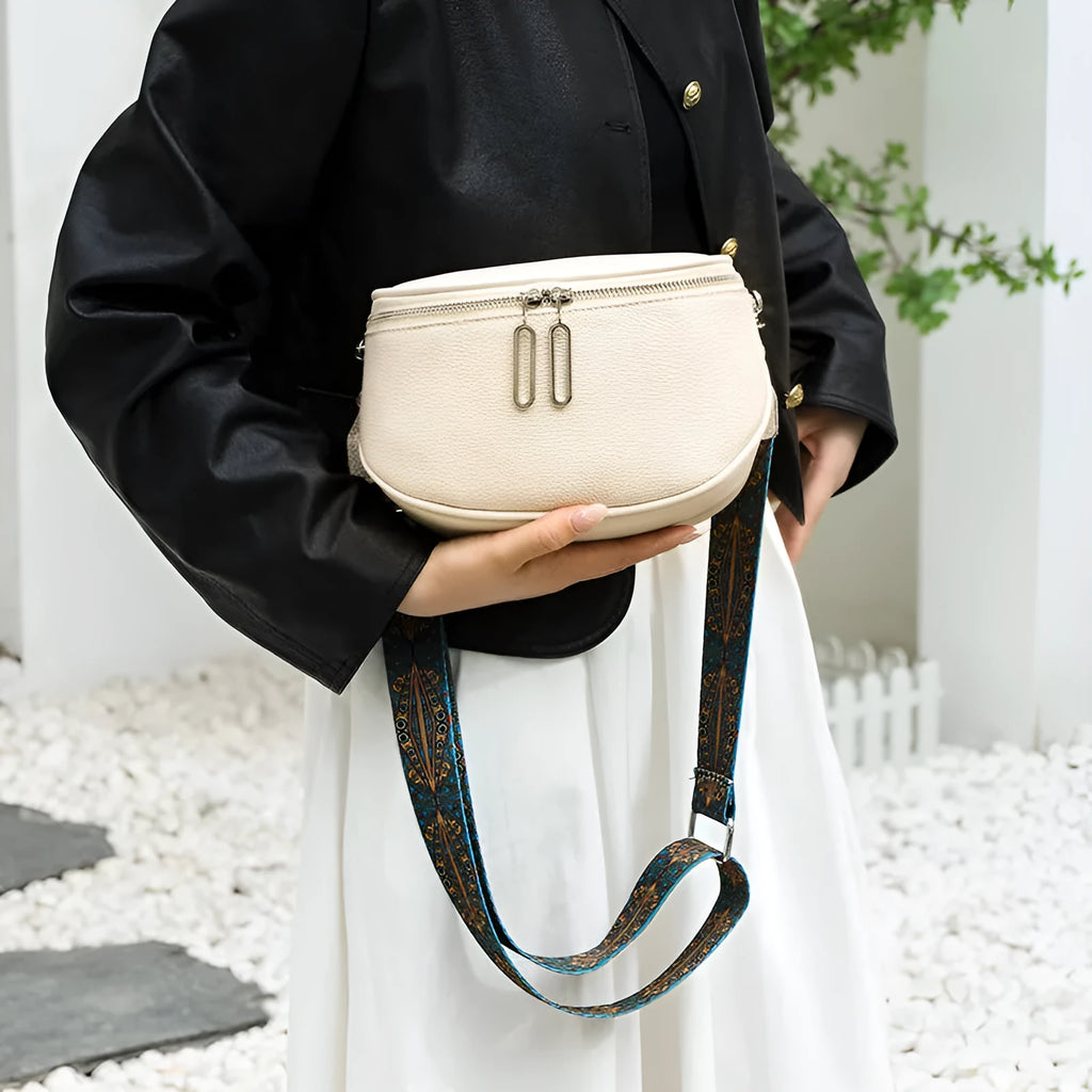A soft black PU leather women's messenger bag with a single strap, shown in a casual saddle shape.