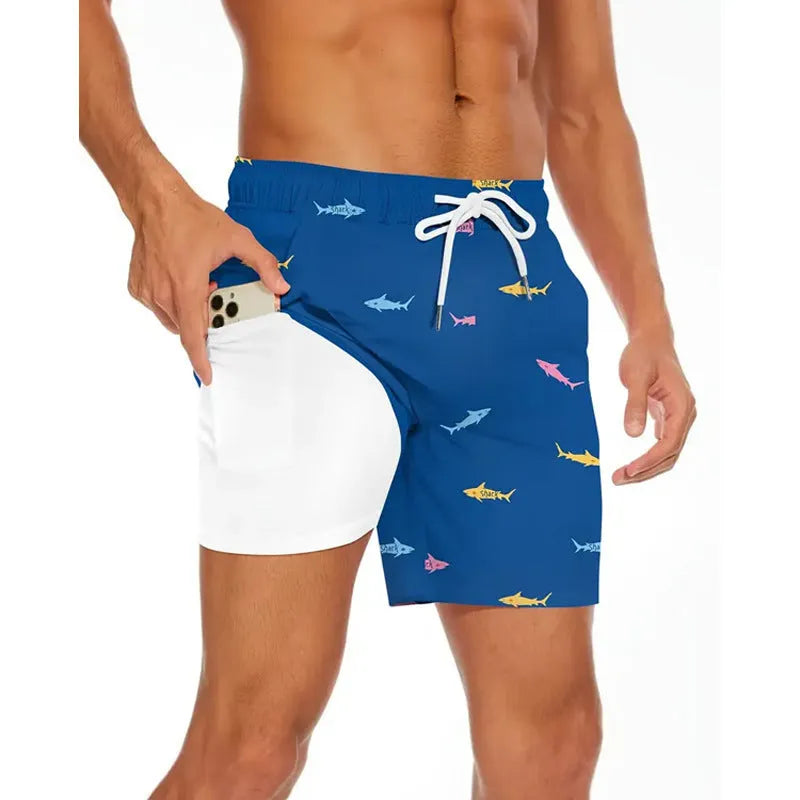 Man wearing loose grey polyester beach shorts, showing sporty casual style.