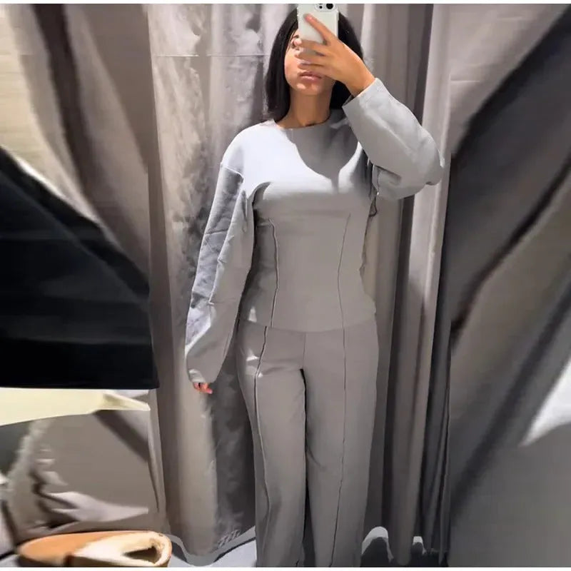Women's polar fleece suit set showing long sleeve pleated top with wide leg trousers in coordinating colours