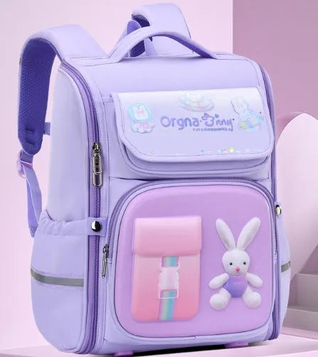 Children's cartoon backpack in Rabbit or Spaceman print with airpillow straps, shown in pink, purple, blue green, or blue red.