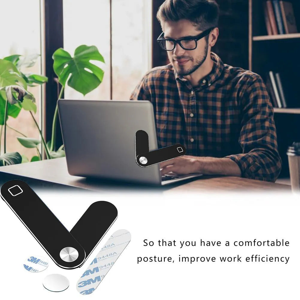 Black aluminium magnetic phone holder clipped to the side of a silver laptop.