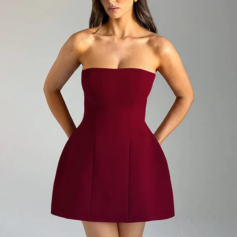 Solid colour backless tube dress with short A-line skirt on a hanger.