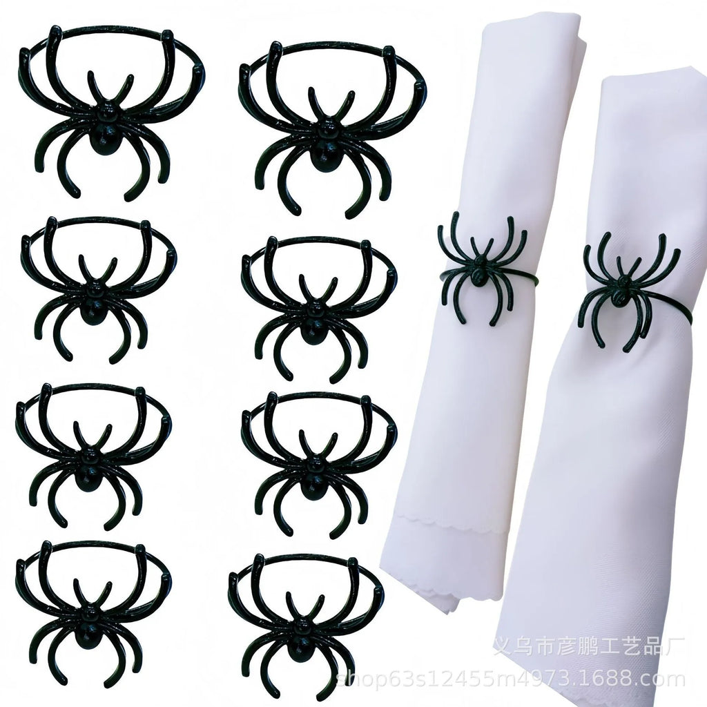 Set of six black alloy napkin rings with spider pattern design for Halloween table decoration