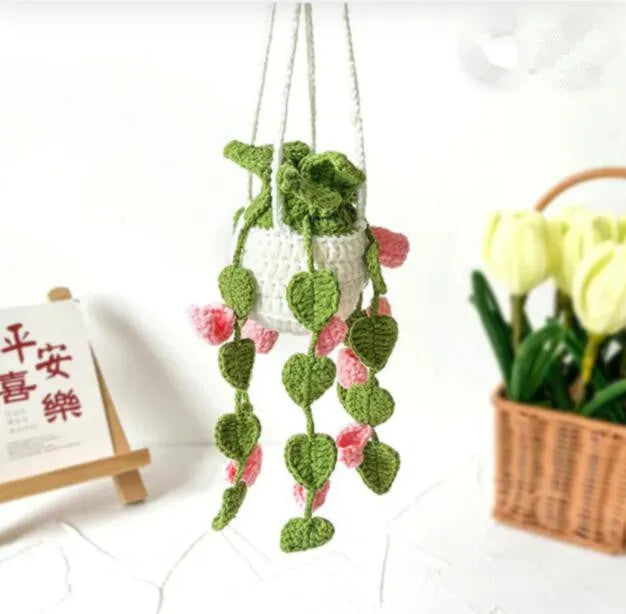 Green and white knitted wool car plant decoration with plastic base and hanging rope