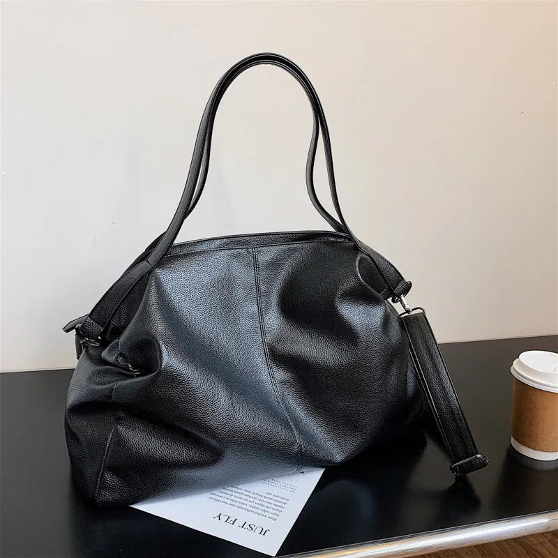 Large soft surface messenger bag in horizontal square shape with adjustable shoulder strap and zipper opening