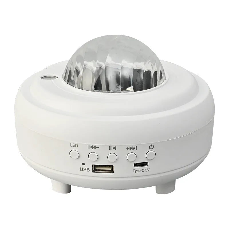 White galaxy star projector with Bluetooth speaker showing star projection on wall