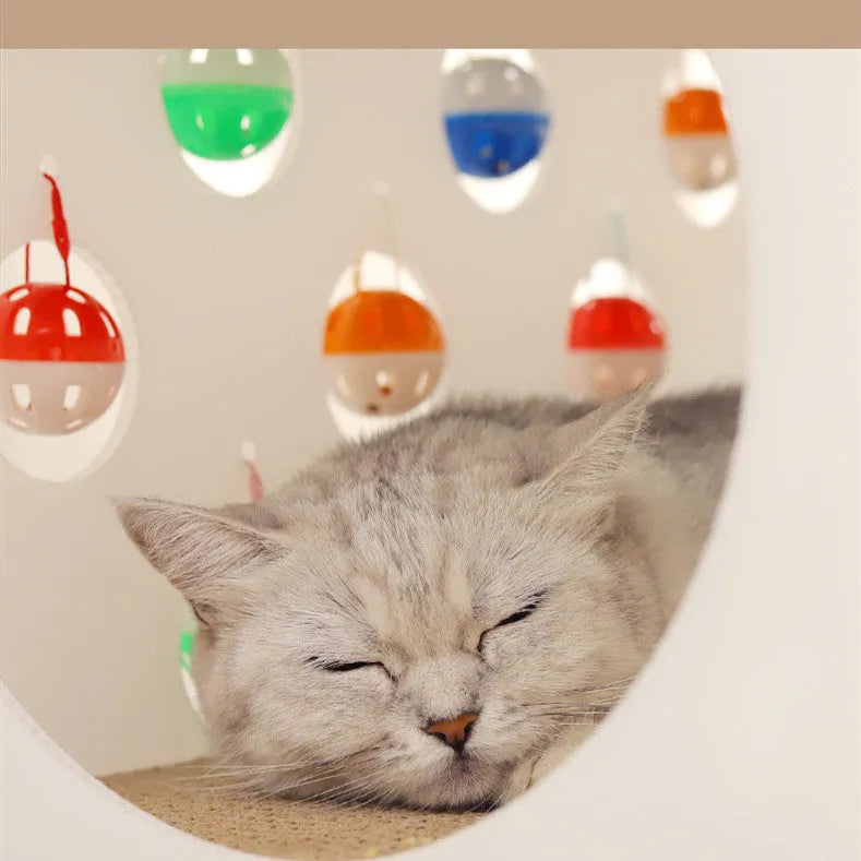 Plastic cat scratch board and bed integrated toy with a built-in tunnel containing a bell ball.