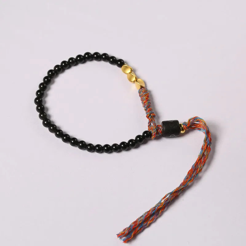 Hand-woven obsidian black wrist strap showing 4mm width and natural cord texture
