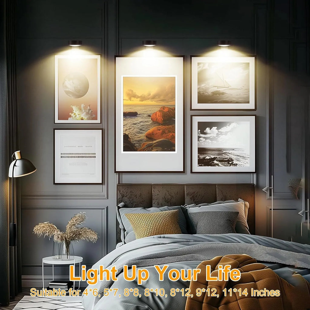 Black remote control LED magnetic picture light mounted above a painting, showing wireless power supply.