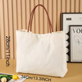 Beige white canvas tote bag with adjustable cotton handles showing reinforced bottom stitching.