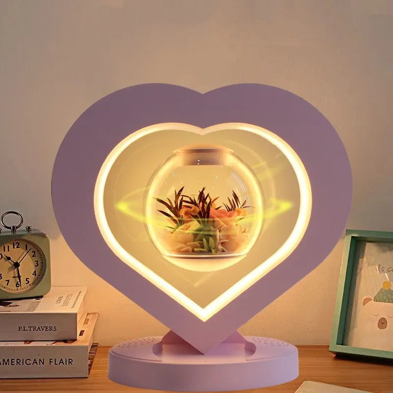 Pink preserved rose ornament with LED lights on a base with audio Bluetooth connectivity.