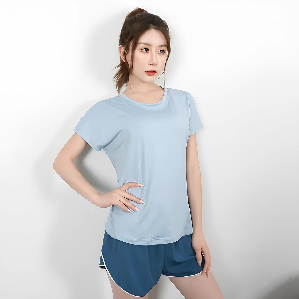 Women's short sleeve polyester sports T-shirt in grey green, shown for running and fitness activities.
