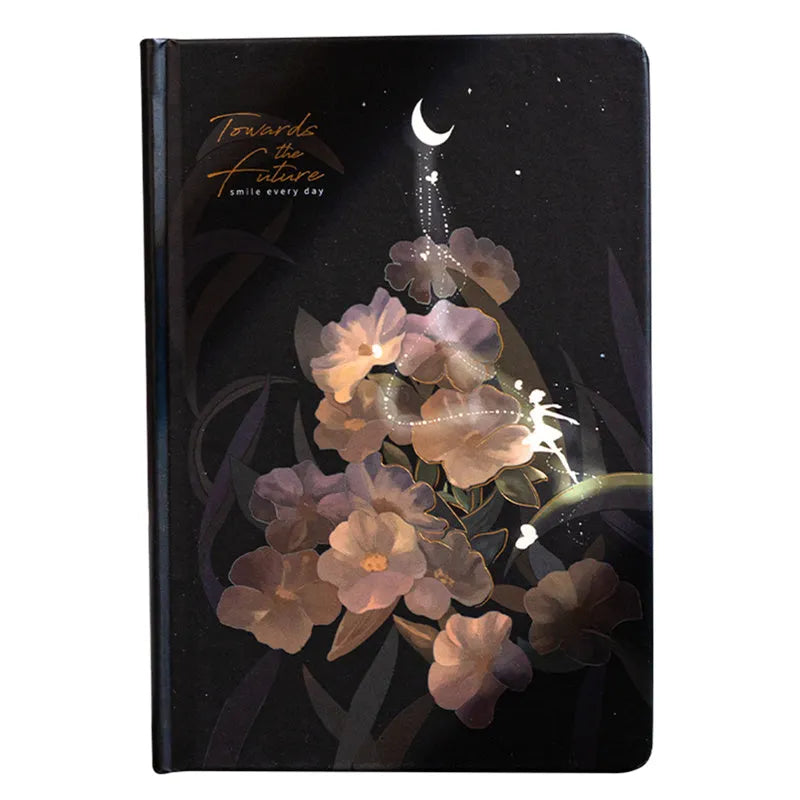A5 notebook with luminous holographic cover lying flat, showing colourful illustrated interior pages.
