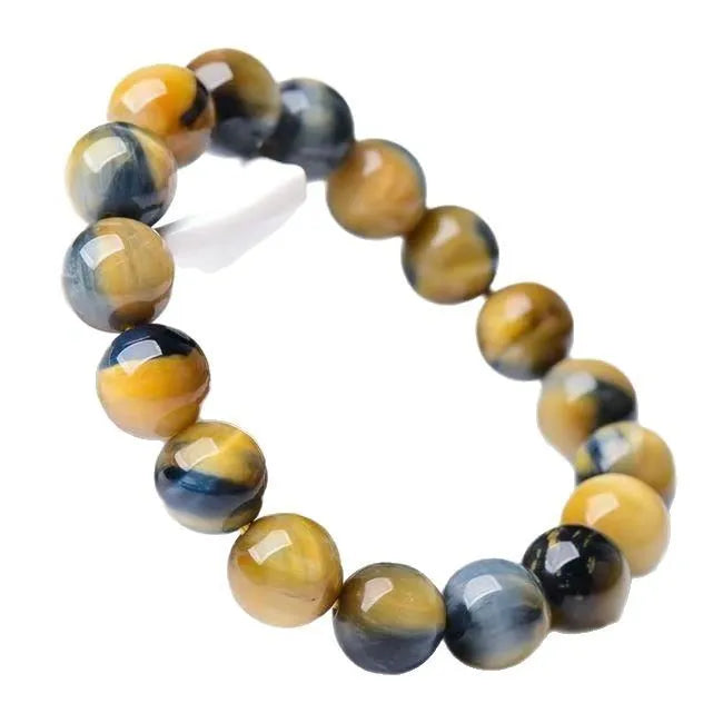 A fantasy tigereye agate bracelet with round beads on a neutral background.