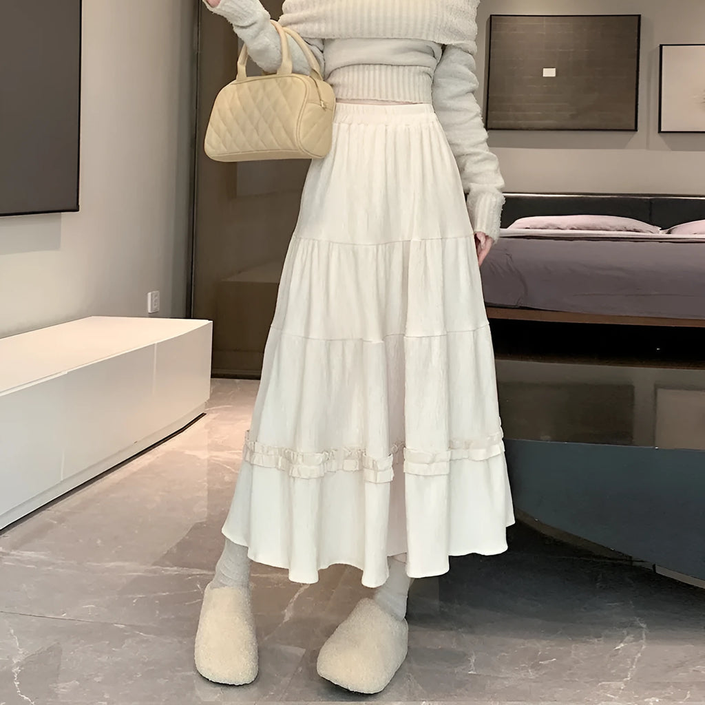Beige corduroy A-line midi skirt with an elastic waistband on a hanger.
