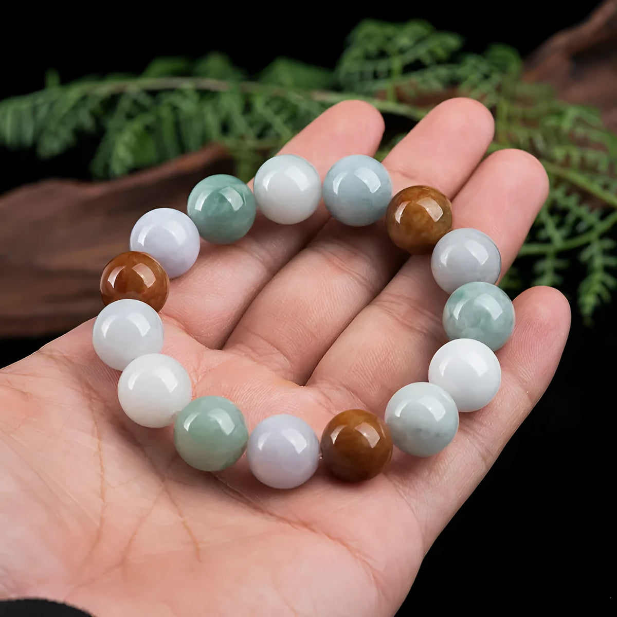 Natural Myanmar jade bracelet with three colours on 13mm round beads showing traditional craftsmanship