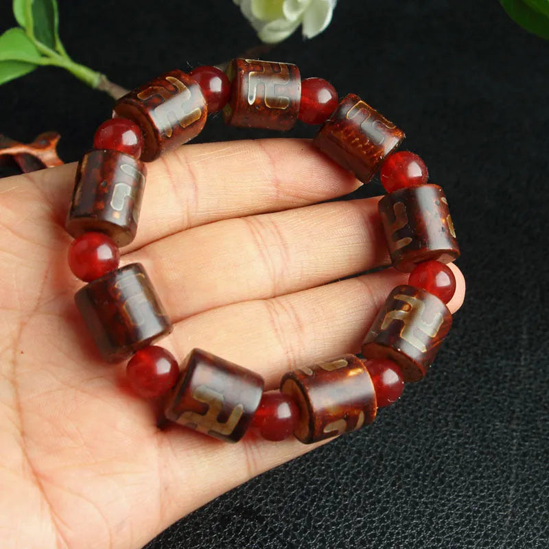 Distressed agate bracelet with traditional Tibetan dzi beads including three-eye and Nine Eyes designs.