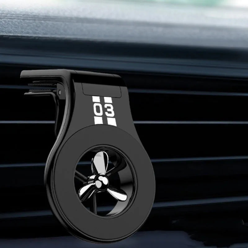 Magnetic car phone holder mounted on vehicle air vent with smartphone attached showing adjustable rotation mechanism