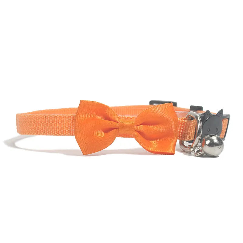 Adjustable striped nylon cat collar with bell in various colors including red, green, and blue