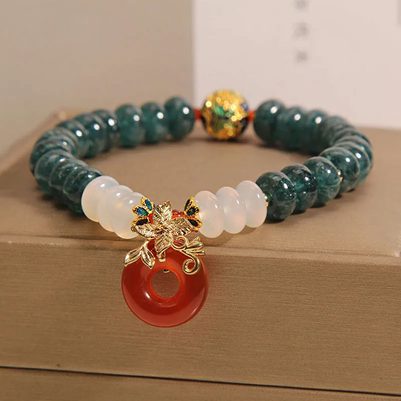Blue water jade and red agate stone bracelet with peace buckle closure on crystal band