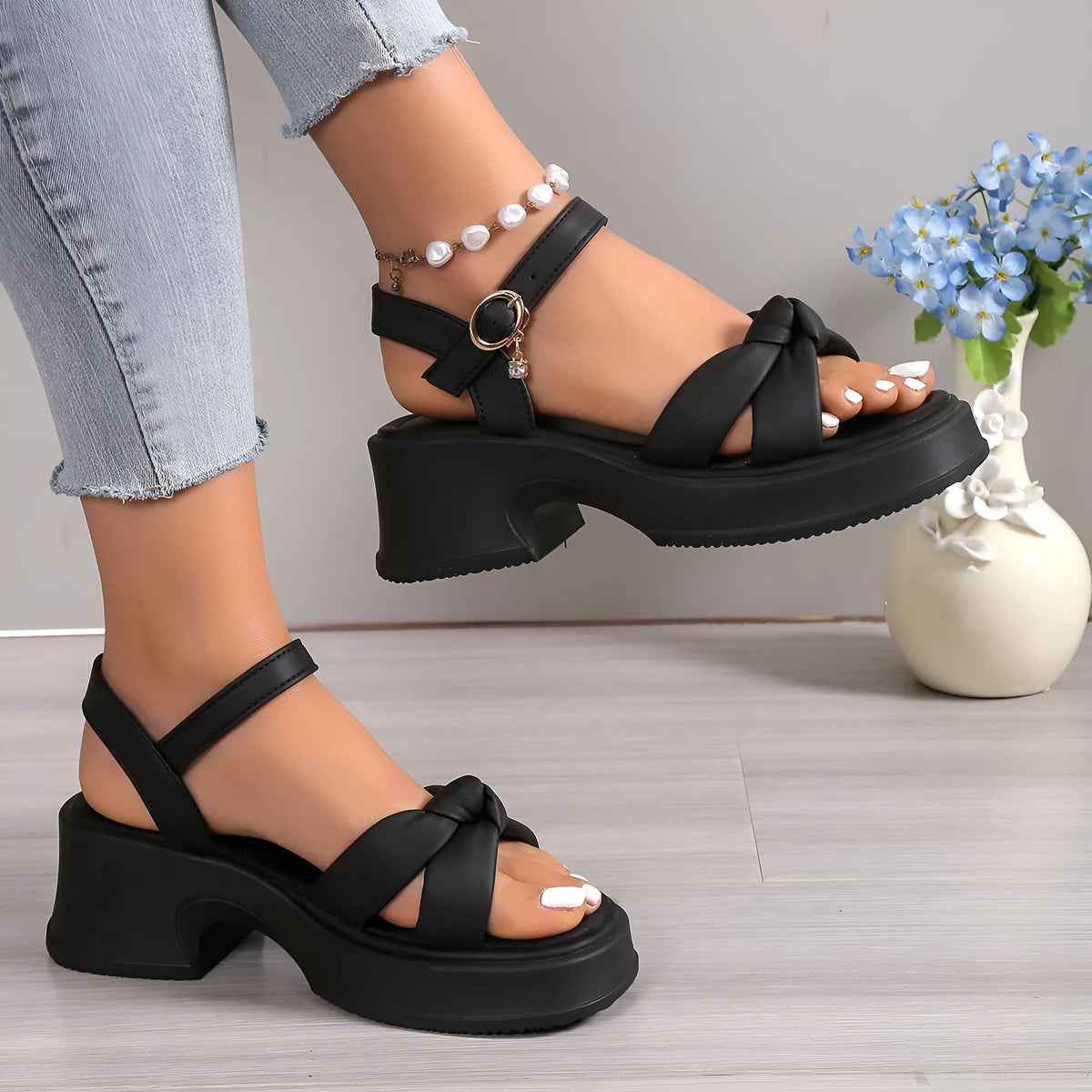 Black high heel slippers with thick rubber sole and button fastening on round toe design