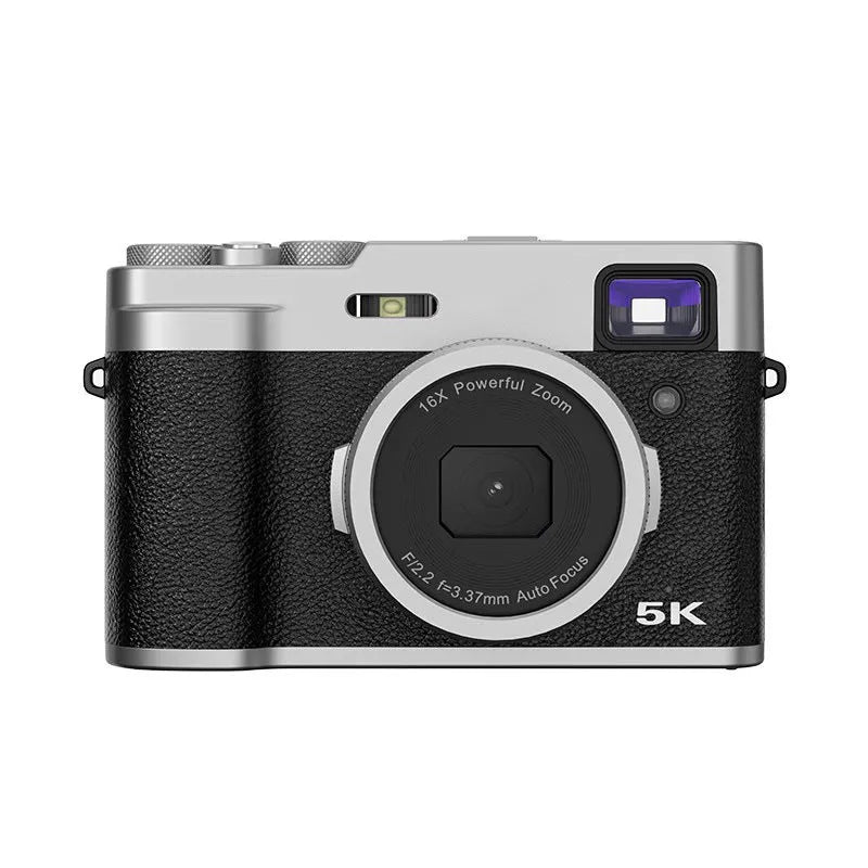 Black 5K HD digital camera with front and rear lenses, 2.88-inch screen, and optical viewfinder on a table with accessories.