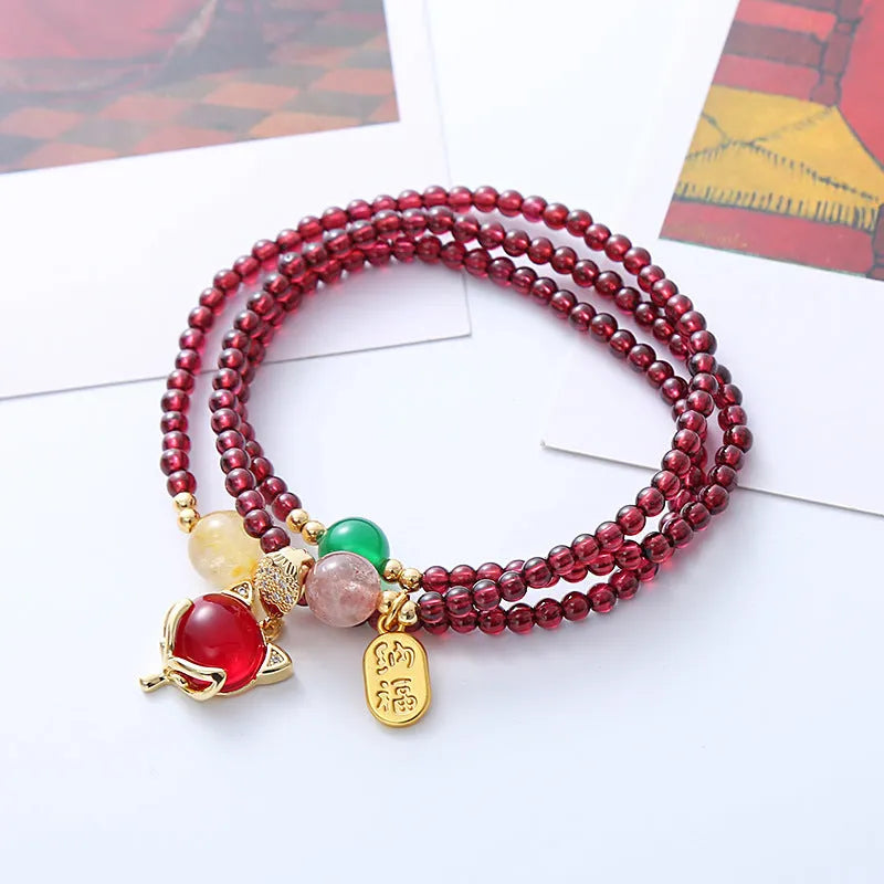 Purplish red garnet crystal fox bracelet on an adjustable rope for women.