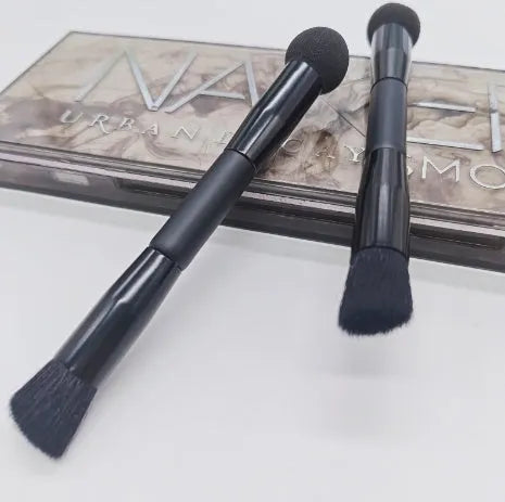 Elegant black double-headed makeup brush with a miter sponge and concealer brush on a wooden handle